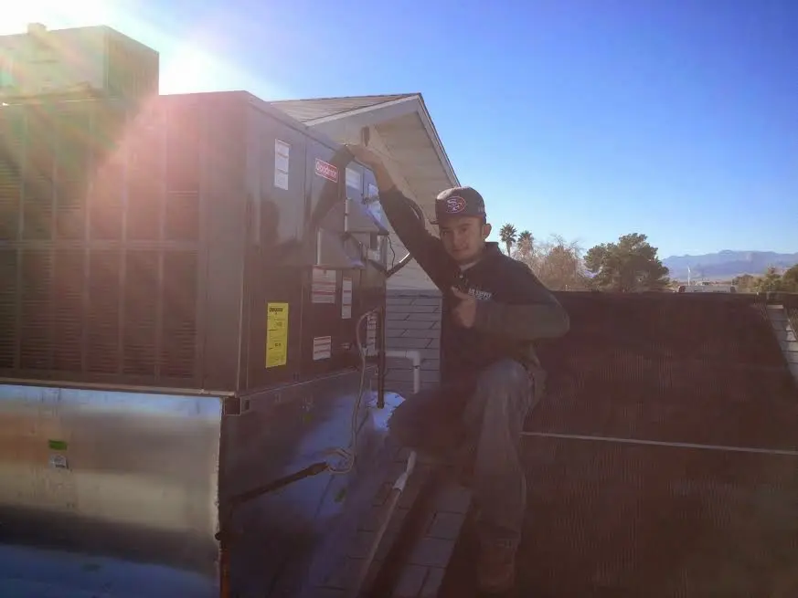 HVAC technician performing AC Tune-Up on a rooftop unit in Sharonville